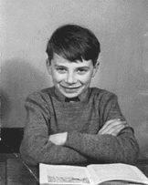 Young Nick wearing his best school sweater and smile.